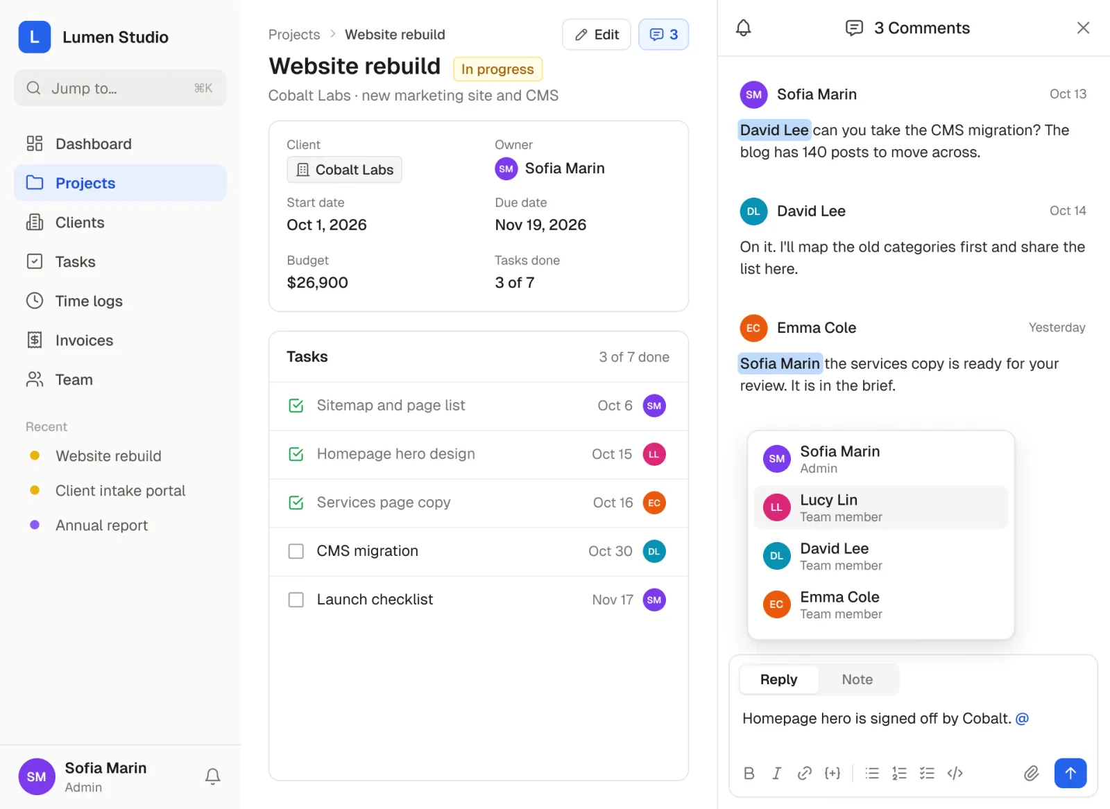 A Website rebuild project with its comments open: teammates are mentioned by name, and typing @ in the reply box lists the people who can be mentioned